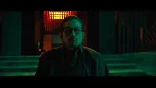 man with glasses in dimly lit room — John Wick: Chapter 4