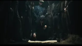 Man kneeling in suit before other men — Peaky Blinders