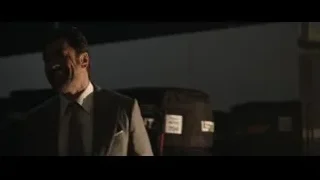 Man in suit in dimly lit room with 'LIFE' bag — F1