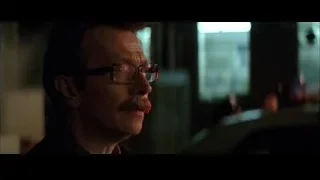 Man with glasses in dimly lit room — Batman