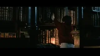 Young boy in library with bookshelf — Harry Potter and the Philosophers Stone