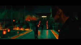Person in garden at night with lanterns — John Wick: Chapter 4