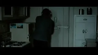 Distressed person in dark kitchen doorway — Limitless