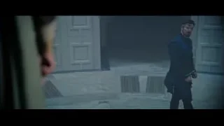 Man in dark coat holding gun in dimly lit room — Doctor Strange 2