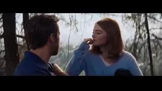 man and woman talking in wooded area — La La Land
