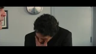 man in suit talking to woman by clock — Now You See Me