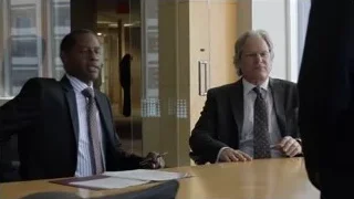 Two men in suits at conference table — Suits