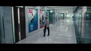 Man walking in modern glass corridor — The Secret Life of Walter Mitty