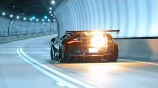 Black sports car driving through futuristic tunnel — Sports Cars