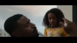 woman with curly hair sitting with man — Creed 3