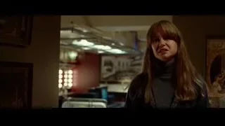 Woman standing in dimly lit room with artworks — Steve Jobs