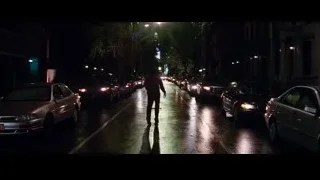 person walking on wet city street at night — The Amazing Spider Man 2