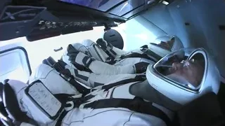 two astronauts in cockpit looking out window — Elon Musk: Return to Space