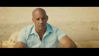 Bald man sitting on sandy beach — Furious Seven