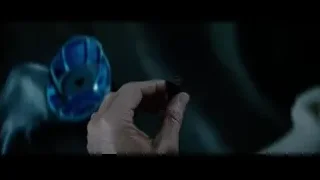 hand holding blue object in dark room — Superman: Man of Steel