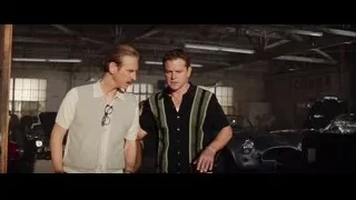 two men conversing in a garage — Ford v Ferrari