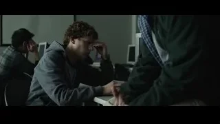 young man deep in thought at office desk — The Social Network