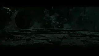 Person in black cloak crouching in eerie cave — Harry Potter and the Deathly Hallows 2