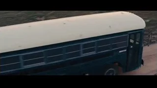 School bus driving on dirt road at sunset — The Wolf Of Wall Street
