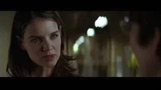 Young woman with serious expression in dimly lit room — Batman