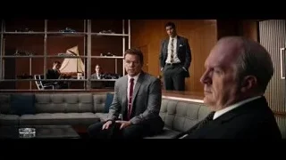two men in suits in room with window — Ford v Ferrari