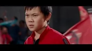 Young boy with serious expression holding flag — The Karate Kid