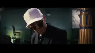 man in suit and white hat in dim room — La La Land