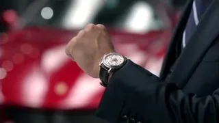 man's wrist with watch on red car — Suits