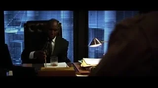 Man in suit deep in thought at office desk — Batman: The Dark Knight