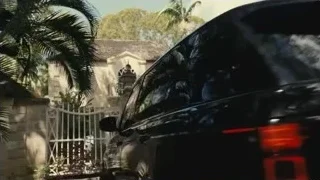 black SUV parked in front of stone gate — Succession