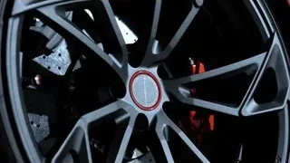 close-up of car wheel with red caliper — Sports Cars