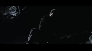 man kneeling in dark silhouette — Batman