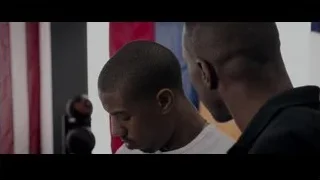 two men standing in front of American flag — Creed