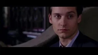 man in dark suit in dimly lit room — Spider Man 2