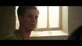 Young man standing by stone window — Hacksaw Ridge
