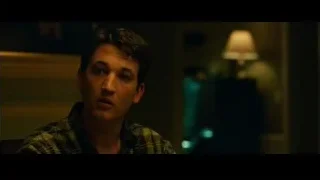 young man in plaid shirt in dimly lit room — Whiplash
