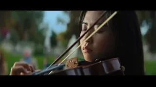 Young woman playing violin in park — John Wick: Chapter 4