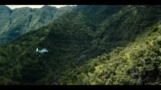 helicopter flying over mountain valley — Jurassic World