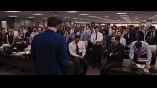 man speaking to group in office — The Wolf Of Wall Street