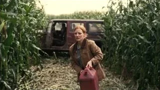 Woman in cornfield with red suitcase — Interstellar