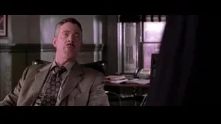 Man sitting in office chair at desk — Spider Man 2