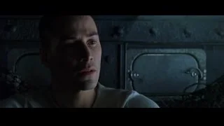 man's face in dark room with metal door — The Matrix