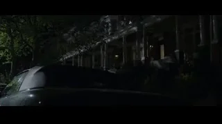 houses lit up at night with car — The Amazing Spider Man
