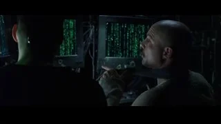 two men at computer monitors in dark room — The Matrix