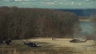 Helicopters flying over grassy field — Succession