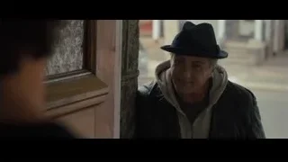 Elderly man looking down at wooden door — Creed 2