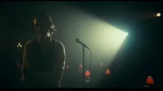 Man singing into microphone on stage — Joker