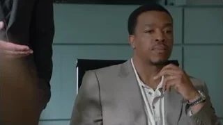 man in suit sitting in office chair — Suits
