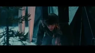 man lying by campfire in snowy woods — Into the Wild