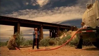 Three men with red hose at construction site — Breaking Bad